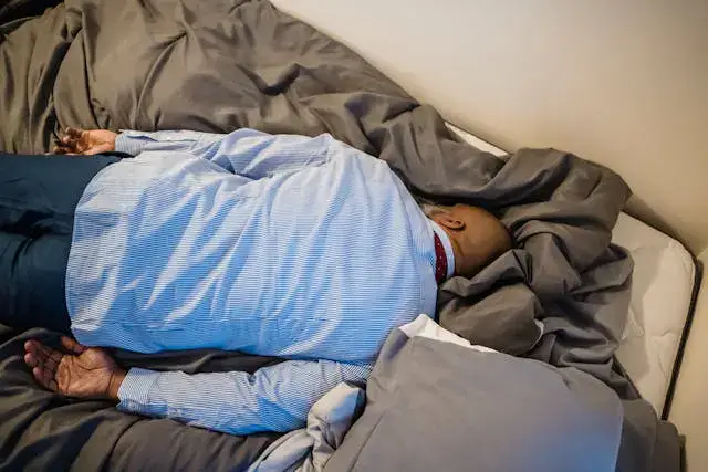 Tired Man in Formalwear Sleeping on Bed